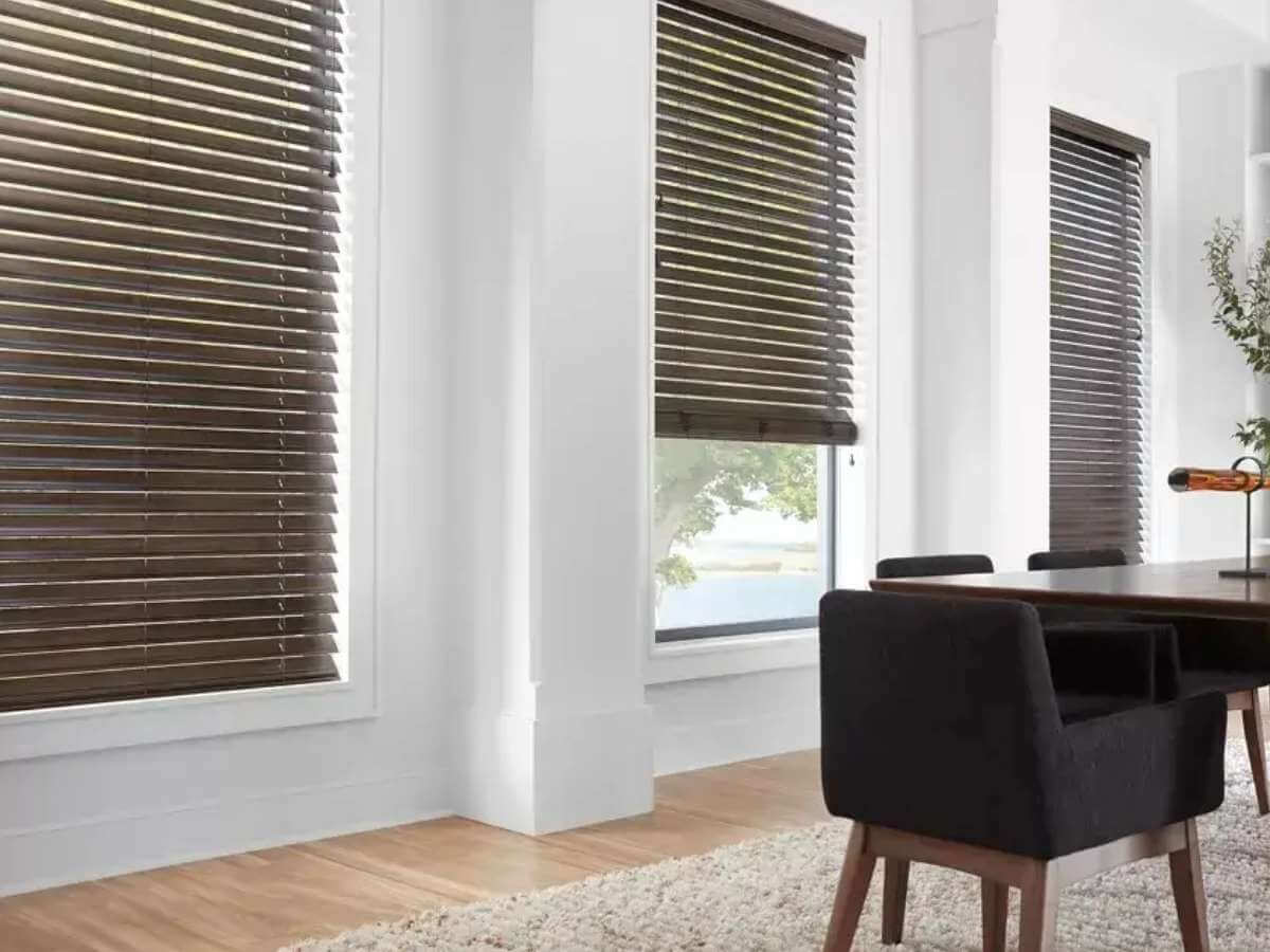 Living room with sleek horizontal blinds partially open, allowing natural light to filter in.